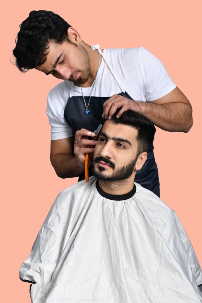 a man cutting another man's hair